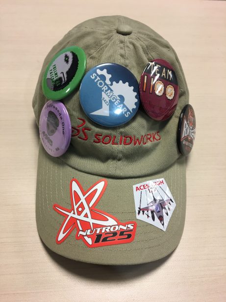 Team buttons on a SOLIDWORKS hat.