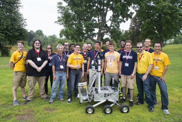 Members of the Mountaineers team from West Virginia University pose for a picture with their robot after successfully recovering two samples during their attempt at the level two challenge during the 2015 Sample Return Robot Challenge, Thursday, June 11, 2015 at the Worcester Polytechnic Institute (WPI) in Worcester, Mass.  Sixteen teams are competing for a $1.5 million NASA prize purse. Teams will be required to demonstrate autonomous robots that can locate and collect samples from a wide and varied terrain, operating without human control. The objective of this NASA-WPI Centennial Challenge is to encourage innovations in autonomous navigation and robotics technologies. Innovations stemming from the challenge may improve NASA's capability to explore a variety of destinations in space, as well as enhance the nation's robotic technology for use in industries and applications on Earth.  Photo Credit: (NASA/Joel Kowsky)